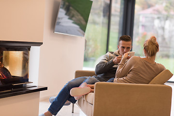 Image showing Young couple  in front of fireplace