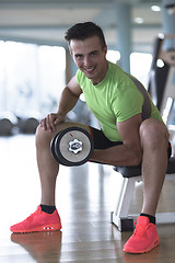 Image showing handsome man working out with dumbbells