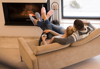 Image showing Young couple  in front of fireplace