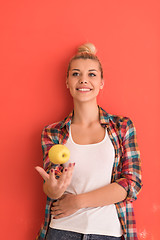 Image showing woman over color background plays with apple