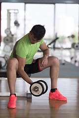 Image showing handsome man working out with dumbbells