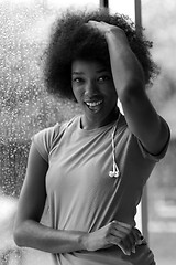 Image showing portrait of young afro american woman in gym while listening mus