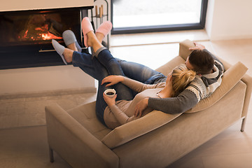 Image showing Young couple  in front of fireplace