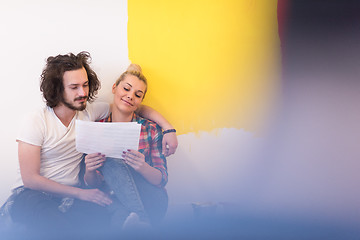 Image showing Happy young couple relaxing after painting