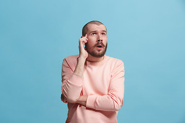 Image showing Young serious thoughtful businessman. Doubt concept.