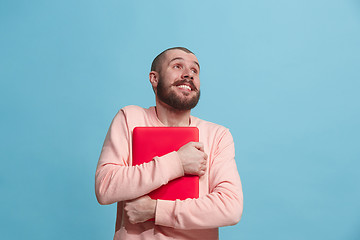 Image showing Businessman hugging laptop at studio