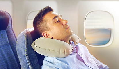 Image showing man sleeping in plane with cervical neck pillow