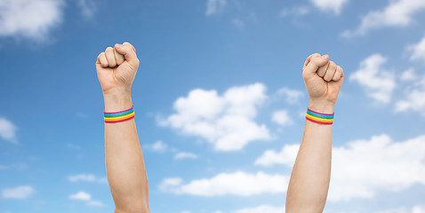 Image showing hands with gay pride rainbow wristbands shows fist