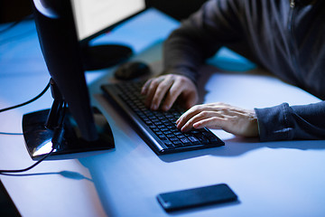 Image showing hacker hands typing on computer keyboard