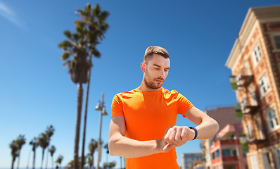 Image showing man with fitness tracker training outdoors