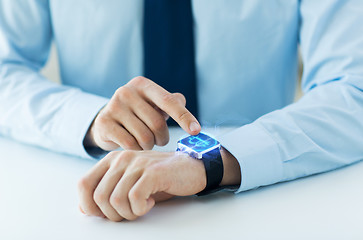 Image showing close up of hands with bitcoin on smart watch