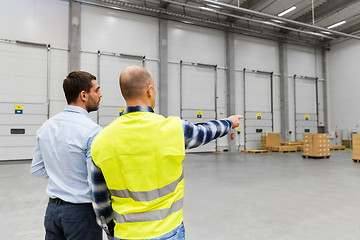 Image showing businessman showing warehouse to worker
