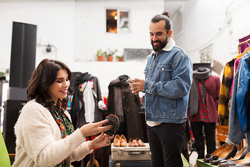 Image showing couple choosing footwear at vintage clothing store