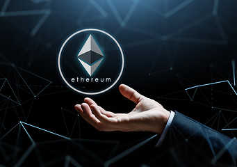 Image showing businessman hand with ethereum over low poly