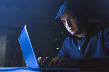 Image showing hacker using laptop computer for cyber attack