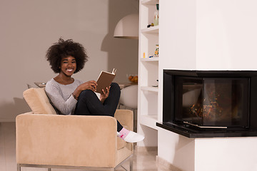 Image showing black woman at home reading book