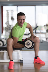 Image showing handsome man working out with dumbbells