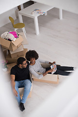 Image showing African American couple  playing with packing material