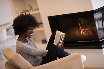 Image showing black woman at home reading book