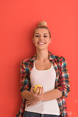 Image showing woman over color background plays with apple