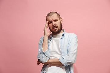 Image showing Man having headache. Isolated over pink background.