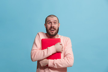 Image showing Businessman hugging laptop at studio