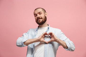 Image showing Portrait of attractive man with kiss isolated over pink background