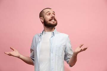 Image showing The happy business man standing and smiling against pastel background.