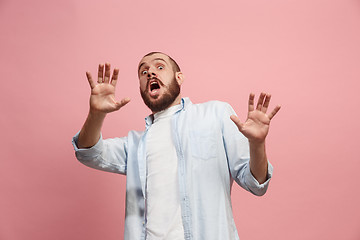 Image showing Portrait of the scared man on pink