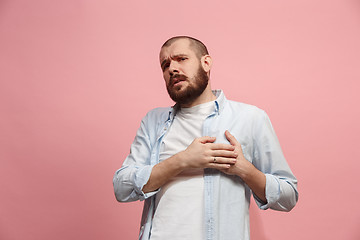 Image showing Man having heart pain. Isolated over pink background.