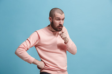 Image showing Suspiciont. Doubtful pensive man with thoughtful expression making choice against pink background