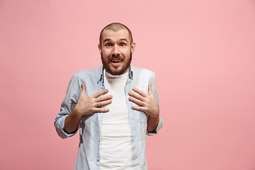 Image showing Let me think. Doubtful pensive man with thoughtful expression making choice against pink background