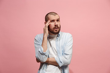 Image showing Young serious thoughtful businessman. Doubt concept.