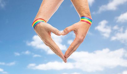 Image showing male hands with gay pride wristbands showing heart