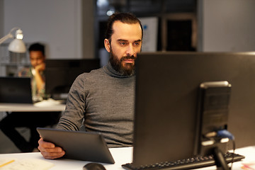 Image showing creative man with computer working late at office