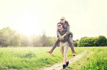 Image showing happy couple with backpacks having fun outdoors