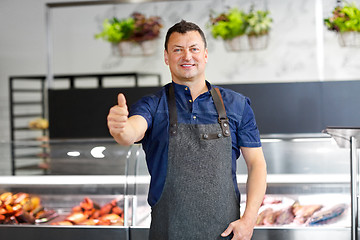 Image showing seafood seller at fish shop showing thumbs up