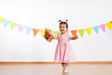 Image showing happy baby girl with teddy bear on birthday party