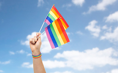 Image showing hand with gay pride rainbow flags and wristband