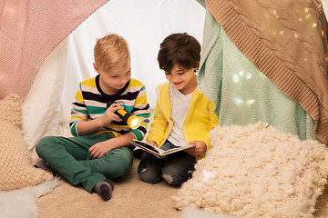 Image showing happy boys reading book in kids tent at home
