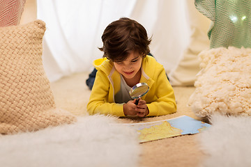 Image showing boy with magnifier and map in kids tent at home