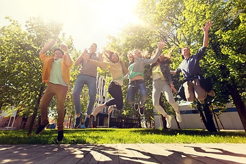 Image showing happy teenage students or friends jumping outdoors