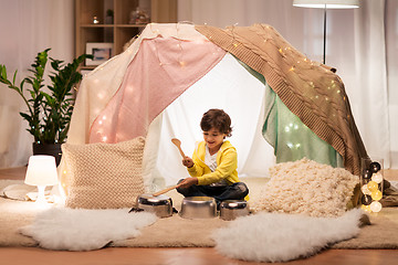 Image showing boy with pots playing music in kids tent at home
