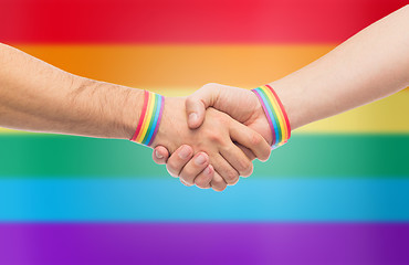 Image showing hands with gay pride wristbands make handshake