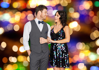 Image showing happy couple hugging at party over festive lights 