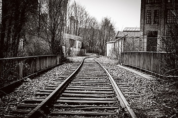 Image showing Railroad tracks going through an abandoned city