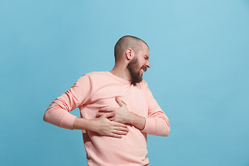 Image showing Man having heart pain. Isolated over blue background.