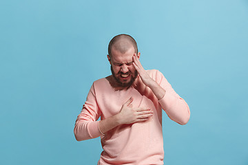 Image showing Man having heart pain. Isolated over blue background.