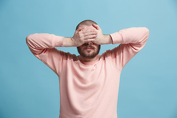 Image showing man covered his face with his hands