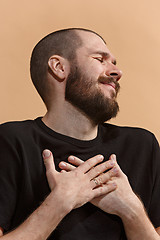 Image showing Isolated on pastel young casual man smiling and enjoying at studio